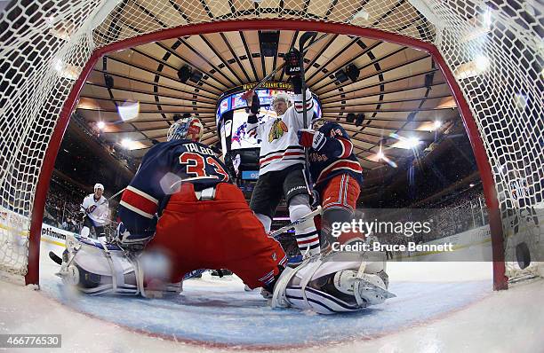 Bryan Bickell of the Chicago Blackhawks celebrates the game winning oal by Brad Richards against Cam Talbot of the New York Rangers during the third...