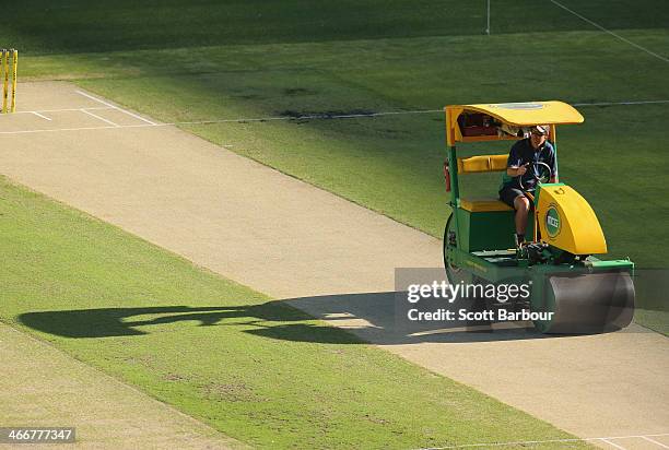 The groundsman rolls the wicket with a cricket pitch roller during the Big Bash League Semi Final match between the Melbourne Stars and the Hobart...