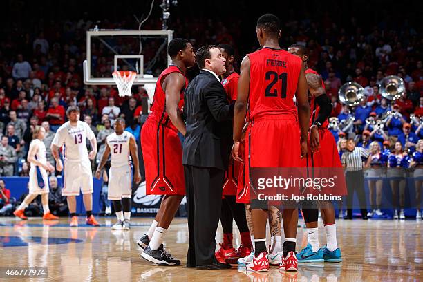 Head coach Archie Miller of the Dayton Flyers huddles with his team in the closing minutes against the Boise State Broncos during the first round of...