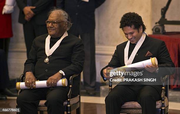 Indian scientist Chintamani Nagesa Ramachandra Rao and cricketer Sachin Tendulakr smile after receiving the "Bharat Ratna" award from Indian...