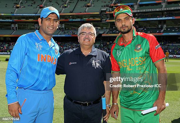 Dhoni of India and Mashrafe Mortaza of Bangladesh pose with a competition winner after the coin toss during the 2015 ICC Cricket World Cup match...