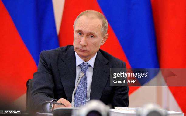 Russia's President Vladimir Putin chairs a meeting during his visit to the ancient Russian city of Pskov, on February 3, 2014. Russia's top...