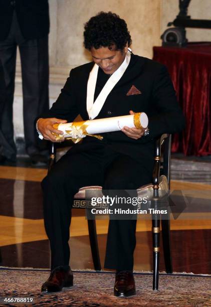 Indian cricketer Sachin Tendulakr smiles after receiving the Bharat Ratna award from Indian President Pranab Mukherjee during an awards ceremony at...