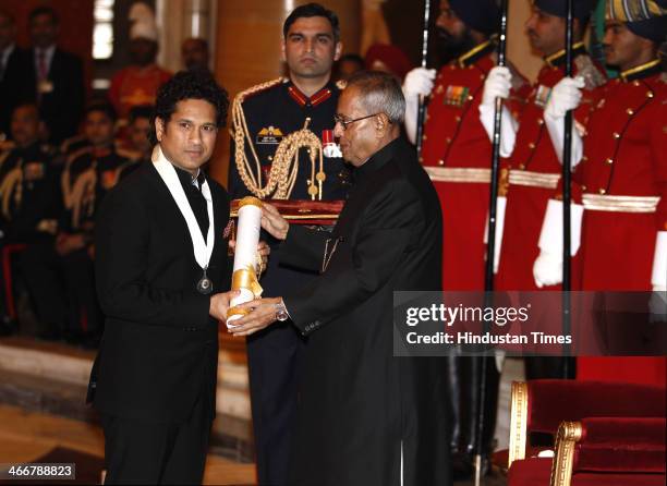 Indian cricketer Sachin Tendulkar receives the Bharat Ratna award from Indian President Pranab Mukherjee during an awards ceremony at the...