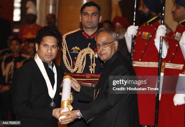 Indian cricketer Sachin Tendulkar receives the Bharat Ratna award from Indian President Pranab Mukherjee during an awards ceremony at the...