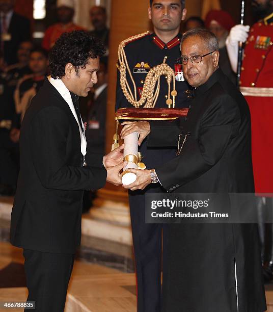 Indian cricketer Sachin Tendulkar receives the Bharat Ratna award from Indian President Pranab Mukherjee during an awards ceremony at the...