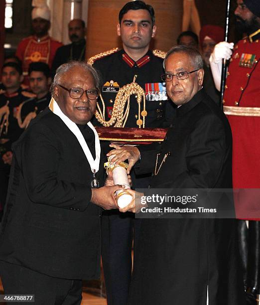 Indian scientist Chintamani Nagesa Ramachandra Rao receives the Bharat Ratna award from Indian President Pranab Mukherjee during an awards ceremony...