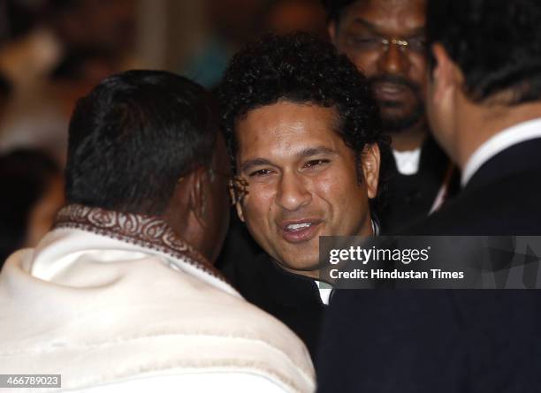 Retired Indian cricketer Sachin Tendulkar interacts with the guests before receiving the Bharat Ratna award by President Pranab Mukherjee at India's...