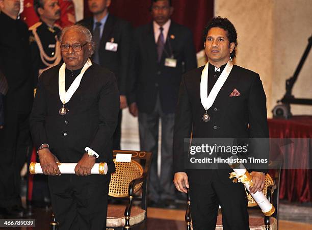 India cricketer Sachin Tendulkar and scientist Chintamani Nagesa Ramachandra Rao pose for the media during an awards ceremony at the Presidential...