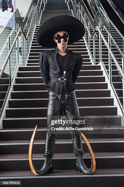 Guest is seen wearing vintage hat and jacket, trousers by Yves Saint Laurent, shoes by Garrison and spectacles by Jeremy Scott during the Mercedes...