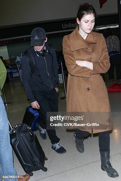 Logan Lerman and Alexandra Daddario seen at LAX on March 18, 2015 in Los Angeles, California.