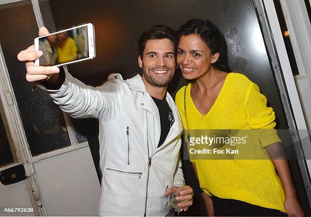 Laurence Roustandjee poses for a selfie with a guest during the Basus Cocktail at Le Perchoir on March 18, 2015 in Paris, France.