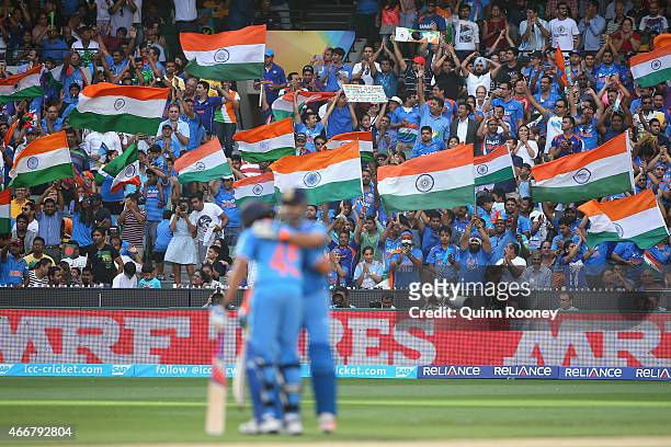 Fans celebrate as Suresh Raina of India celebrates making 50 runs during the 2015 ICC Cricket World Cup Quater Final match between India and...