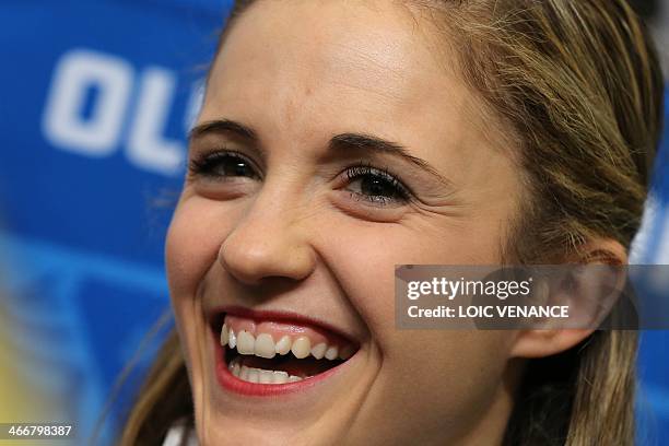 Canada's pair figure skater Paige Lawrence smiles during a press conference ahead of the Sochi Winter Olympics on February 4, 2014. AFP PHOTO/LOIC...