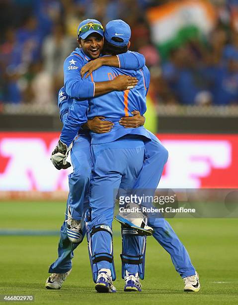 Dhoni and Suresh Raina of India celebrate taking the wicket of Soumya Sarkar of Bangladesh during the 2015 ICC Cricket World Cup match between India...