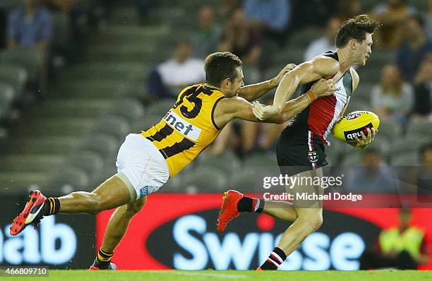 Luke Hodge tackles Jack Steven of the Saints during the NAB Challenge AFL match between St Kilda Saints and Hawthorn Hawks at Etihad Stadium on March...