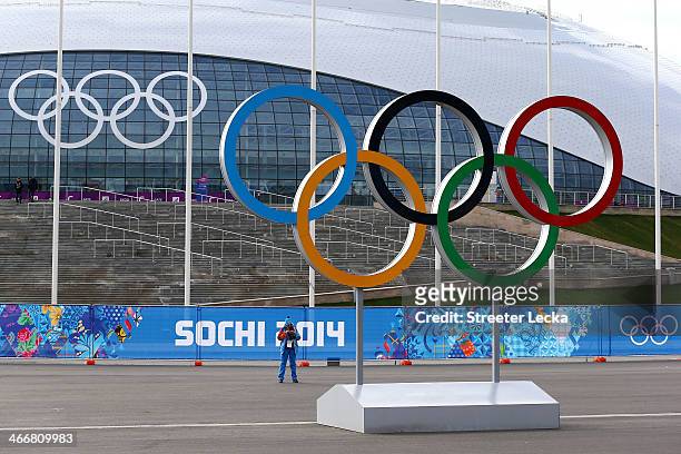 Volunteer stands near the Olympic rings outside Bolshoy Ice Dome ahead of the Sochi 2014 Winter Olympics at the Olympic Park on February 4, 2014 in...