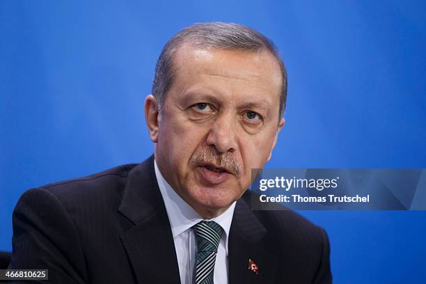 Turkish Prime Minister Recep Tayyip Erdogan speaks to the media following talks with German Chancellor Angela Merkel at the Chancellery on February...