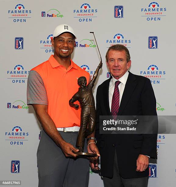Player of the Year recipient Tiger Woods with the Jack Nicklaus Trophy, poses with PGA TOUR Commissioner Tim Finchem at the Farmers Insurance Open at...