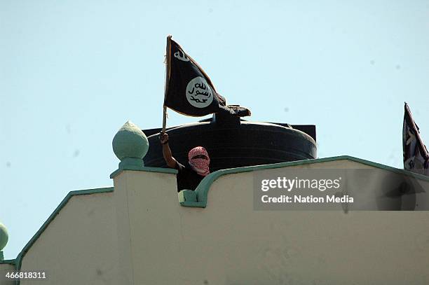 One of the youth on top of the Masjid Musa as the police raid the mosque on February 2, 2014 in Mombasa, Kenya. Police raided the mosque saying...