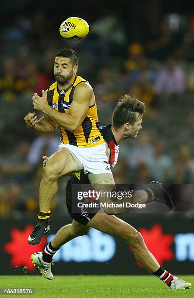 Paul Puopolo of the Hawks competes for the ball against Dylan Roberton of the Saints during the NAB Challenge AFL match between St Kilda Saints and...