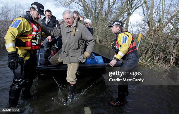 Prince Charles, Prince of Wales gets off a humanitarian support boat as he visits the flood hit village of Muchelney to meet residents affected by...