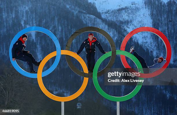 Dominic Harrington, Ben Kilner and Billy Morgan of the Great Britain Snowboard Team pose for a portrait on the Olympic rings at the Athletes Village...