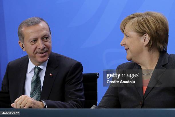 Turkish Prime Minister Recep Tayyip Erdogan and German Chancellor Angela Merkel attend a joint press conference after their meeting at the German...