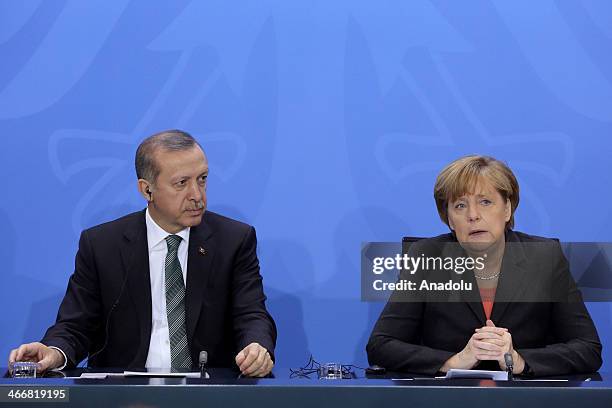 Turkish Prime Minister Recep Tayyip Erdogan and German Chancellor Angela Merkel attend a joint press conference after their meeting at the German...