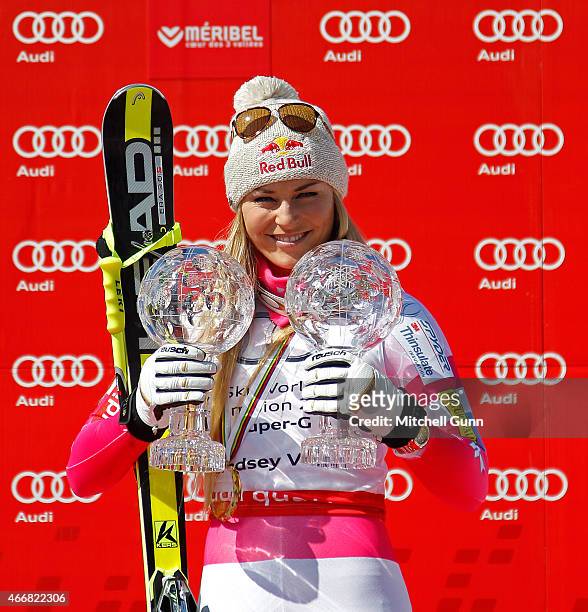 Lindsey Vonn of the USA with the crystal globes for overall Super G winner and Downhill on the podium of the FIS Alpine Ski World Cup women's Super-G...