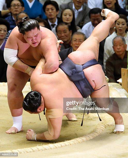 Mongolian sekiwake Terunofuji throws Toyonoshima to win during day twelve of the Grand Sumo Spring Tournament at Bodymaker Colosseum on March 19,...