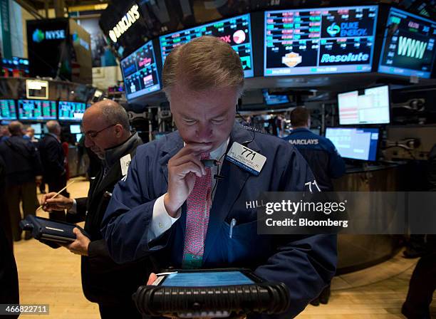 Trader works on the floor of the New York Stock Exchange in New York, U.S., on Tuesday, Feb. 4, 2014. U.S. Stocks rose, with the Standard & Poor's...