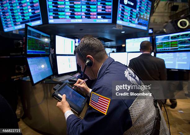 Trader works on the floor of the New York Stock Exchange in New York, U.S., on Tuesday, Feb. 4, 2014. U.S. Stocks rose, with the Standard & Poor's...