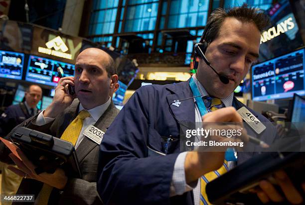 Gregory Rowe, a trader with Livermore Trading Group Inc., right, works on the floor of the New York Stock Exchange in New York, U.S., on Tuesday,...