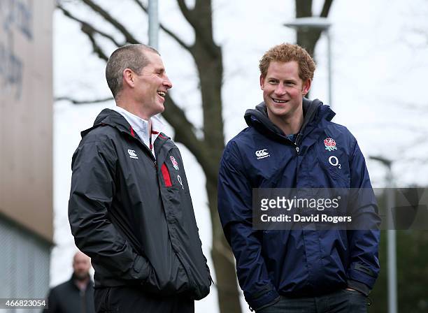 Stuart Lancaster the head coach of England and Prince Harry chat during the England Training Session at Pennyhill Park on March 19, 2015 in Bagshot,...