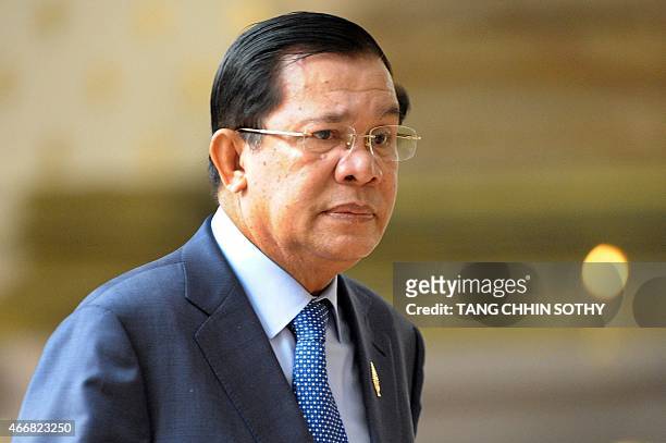 Cambodian Prime Minister Hun Sen walks into the National Assembly meeting in Phnom Penh on March 19, 2015. Cambodian MPs approved two controversial...