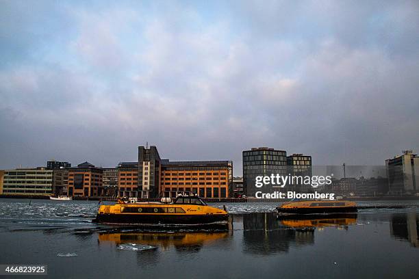 Two Movia water buses pass as they carry commuters along the waterway at Sydhavnen in Copenhagen, Denmark, on Tuesday, Feb. 4, 2014. Opposition to...