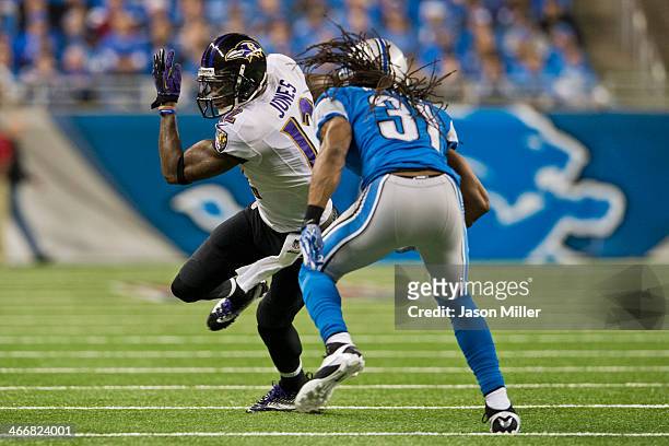 Wide receiver Jacoby Jones of the Baltimore Ravens runs for a gain while under pressure from cornerback Rashean Mathis of the Detroit Lions during...