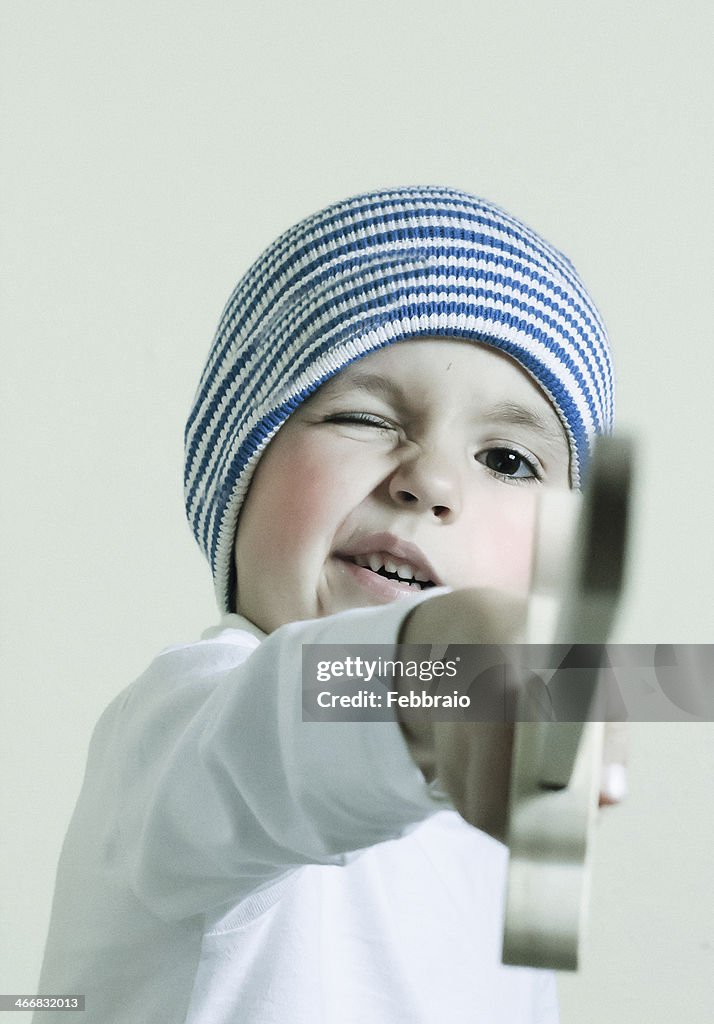 Portrait of child with knitted hat and sword