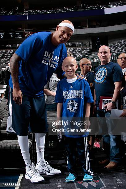 Charlie Villanueva of the Dallas Mavericks poses for photos with fans before a game against the Orlando Magic on March 18, 2015 at the American...