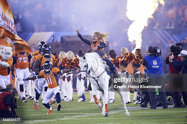 Super Bowl XLVIII: Ann Judge-Wegener riding on Denver Broncos mascot Thunder, leading team onto field before game vs Seattle Seahawks at MetLife...