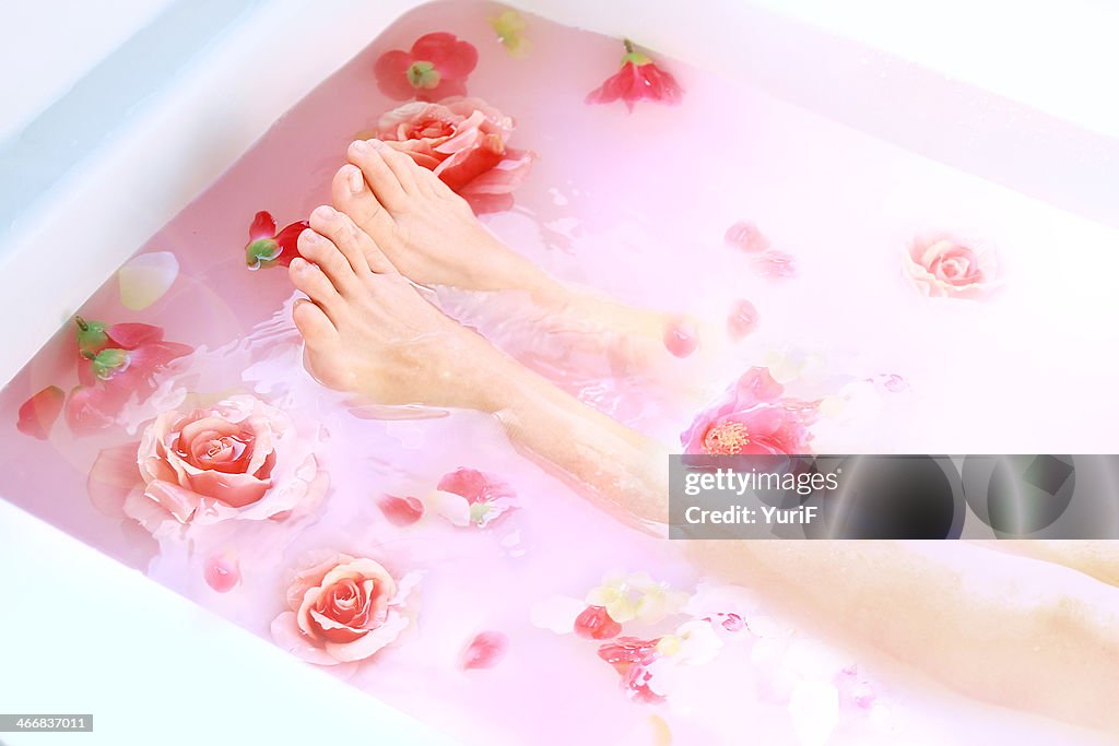 Legs and roses in hot bath.