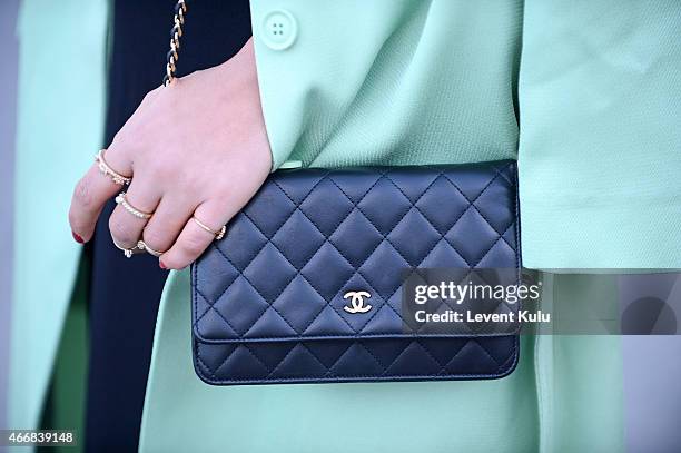 Duygu Senyurek poses wearing dress by Trendyol and hand bag by Chanel during Mercedes Benz Fashion Week Istanbul FW15 on March 18, 2015 in Istanbul,...