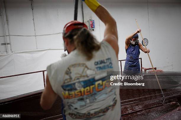 Workers apply fiberglass to an inboard speed boat mold at the Mastercraft Boat Co. Factory in Vonore, Tennessee, U.S. On Tuesday, Feb. 4, 2014....