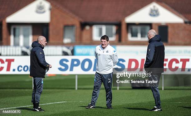 Head Coach John Carver stands on the training pitch with First Team Coach Steve Stone and Coach Dave Watson during a Newcastle United Training...