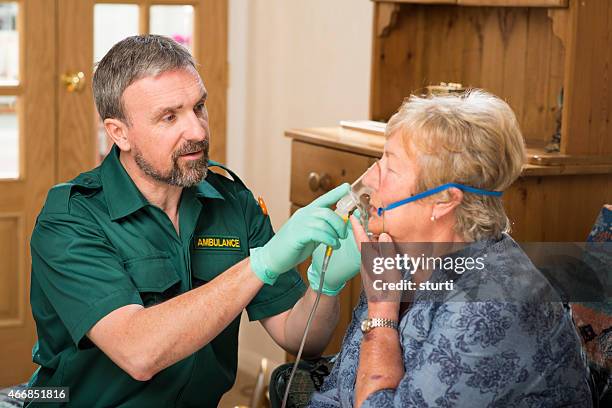 paramedic calms his asthma patient down - paramedic stock pictures, royalty-free photos & images