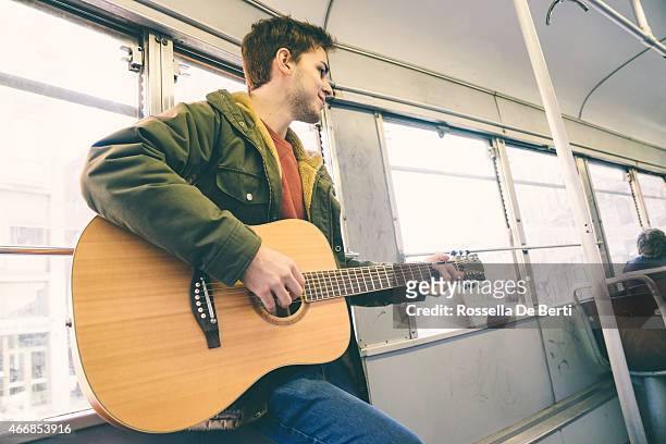 guitar player performing on public transport - play bus stock pictures, royalty-free photos & images