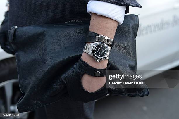 Ali Bayramoglu poses wearing glove by Que, watch by Rolex and hand bag by Givency during Mercedes Benz Fashion Week Istanbul FW15 on March 19, 2015...