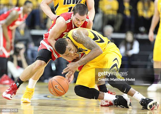 Guard Roy Devyn Marble of the Iowa Hawkeyes battles for a loose ball during the first half against guard Aaron Craft of the Ohio State Buckeyes on...