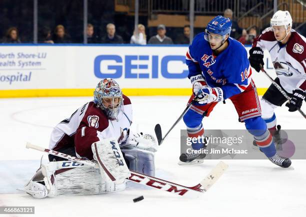 Semyon Varlamov of the Colorado Avalanche makes a save in the second period under pressure from Derick Brassard of the New York Rangers at Madison...